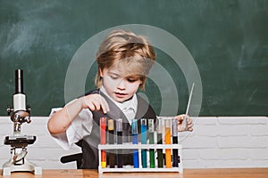 Science. Preschooler. Little kid scientist earning chemistry in school lab. Child in the class room with blackboard on