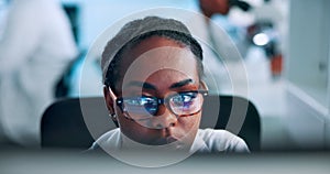 Science, research and black woman at computer reading results in pharmaceutical study in laboratory. Glasses, reflection