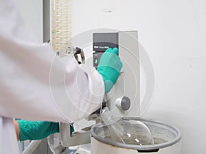 A Science Researcher Doing Evaporation for Extraction of Compound