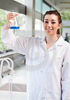 A science student holding an Erlemeyer flask