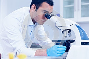 Science student looking through microscope in the lab