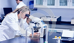 Science student looking through microscope in the lab