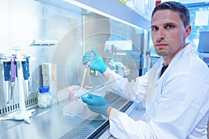 Science student using pipette in the lab