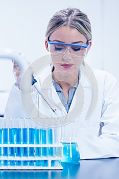 Science student using pipette in the lab