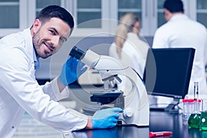 Science student working with microscope in the lab