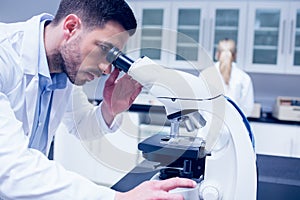 Science student working with microscope in the lab