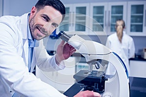 Science student working with microscope in the lab