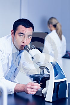 Science student working with microscope in the lab