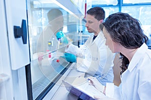 Science students using pipette in the lab