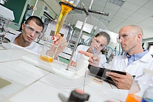 Science students working with chemicals in lab at university