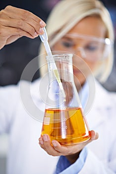 Science, study and woman with liquid in beaker for medical research, vaccine innovation or analysis. Laboratory