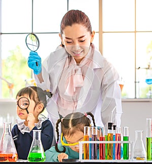 Science teacher teach students in laboratory room