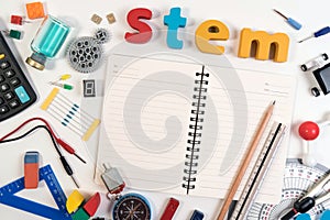 Science Technology Engineering Mathematics. STEM word on book with education equipment for background.