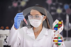 Science, test tube and woman in mask for medical research, experiment and dna. Scientist, glasses and professional with