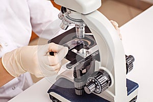 science veterinarian working on microscope. working woman research in lab. medicine, pet, health care and people concept