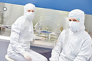 science workers in protective uniform at laboratory research work