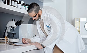 Science, writing and man in laboratory for research, medical report and analytics on clipboard. Pharmaceutical medicine