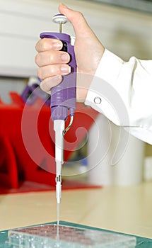 Sciencist Hand holding pipette
