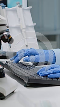 Scientific doctor analyzing sample of blood from vacutainer