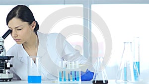 Scientific Reseacher Using Microscope in Laboratory for Experiment