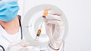 Scientific researcher or doctor using syringe and vaccine in a laboratory with white background. A doctor Filling vaccine to