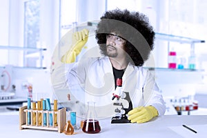 Scientific researcher looking at microscope slide