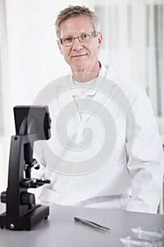 Scientific researcher with microscope