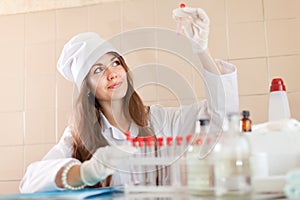 Scientific worker with test tubes