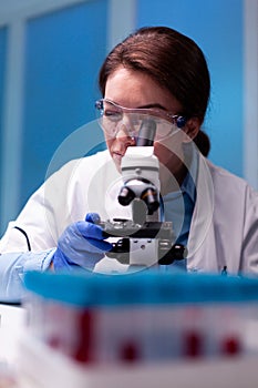 Scientist adjusting microscop pharmacy in laboratory, experiment, expertise, vaccine testing