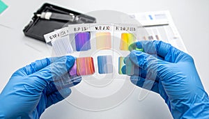 Scientist analyzing a colorimetric lab test chart