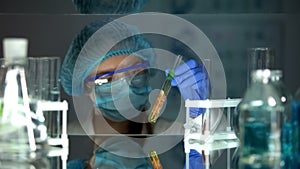 Scientist analyzing meat sample in preservative agent, food quality research