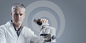 Scientist analyzing samples under the microscope