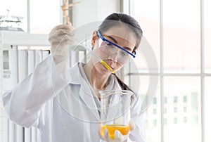 Scientist beautiful woman working and putting medical chemicals sample in test tube at lab office,Close up