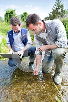 Scientist and biologist working together on water analysis