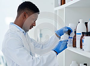 Scientist, chemical and black man with bottle in lab for medical research, information and healthcare. Chemistry