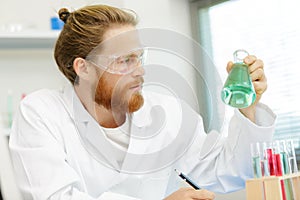Scientist chemist checking chemicals photo