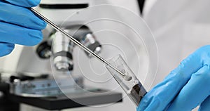 Scientist chemist pouring fertilizer with chemical spoon into test tube with soil in laboratory closeup 4k movie slow