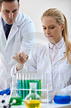 Scientist combining the chemical liquid using a pipette in test