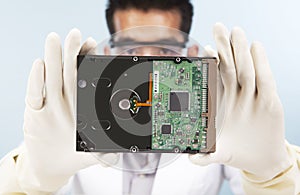 Scientist with computer hard disk