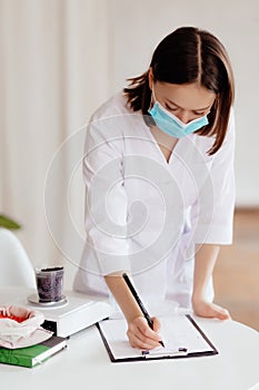 Scientist is conducting experiments, tests with plants in petri dish at laboratory.