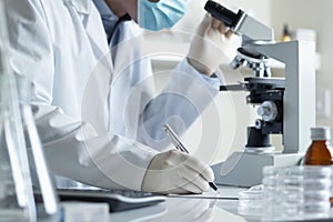 Scientist conducting research with microscope photo