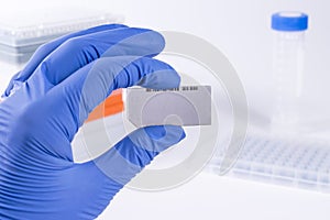 Scientist with DNA Sequencing Chip. Medical laboratory.