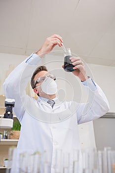 Scientist doing experimentations in flask