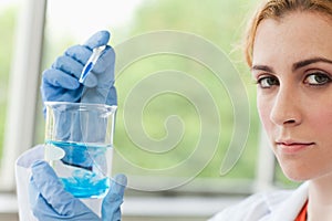 Scientist dropping liquid in a beaker