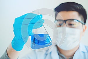 Scientist with equipment holding tools during scientific experiment science concept