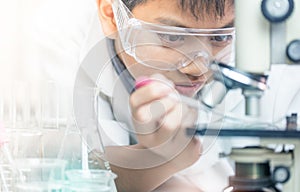 Scientist with equipment and science experiments, laboratory glassware containing chemical liquid for design or decorate science