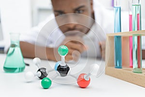 Scientist examining dna model in laboratory