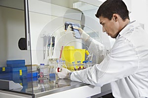 Scientist Filling Test Tube With Hitech Pipette
