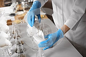 Scientist filtering soil samples at table. Laboratory analysis