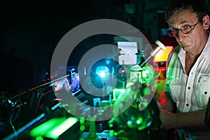 Scientist with glass demonstrate laser